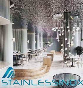 Spacious restaurant interior with high ceiling, elegant decor, and cozy ambiance