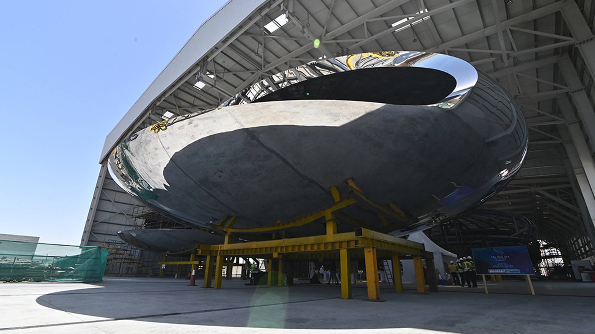 A large metal object with a hole in a hangar