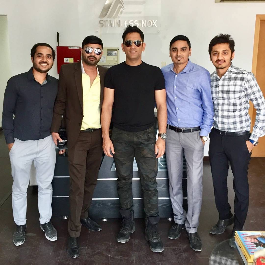 A group of men standing together in front of a desk