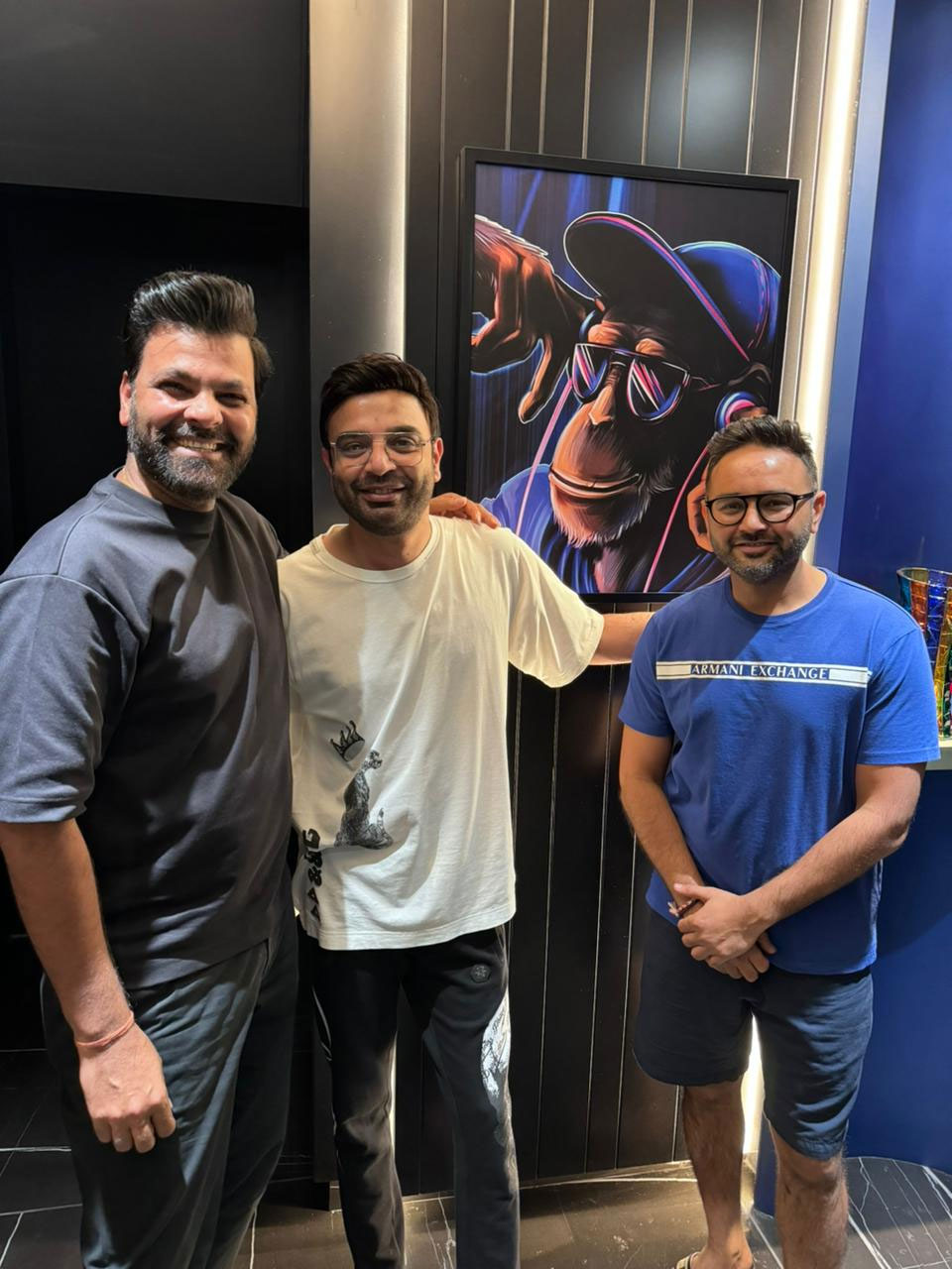 Three men standing in the room