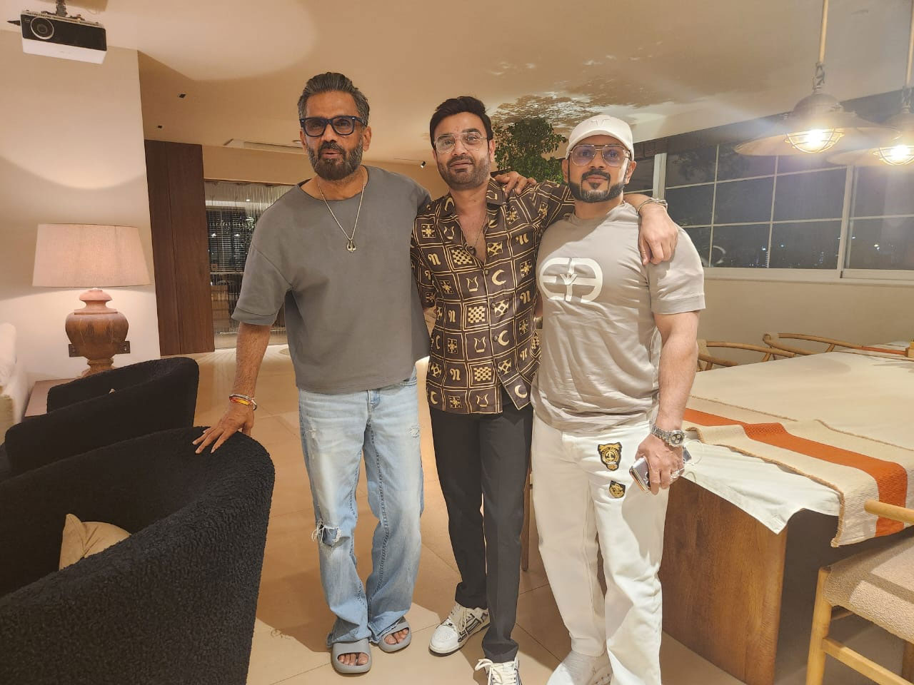 Three men standing in the room