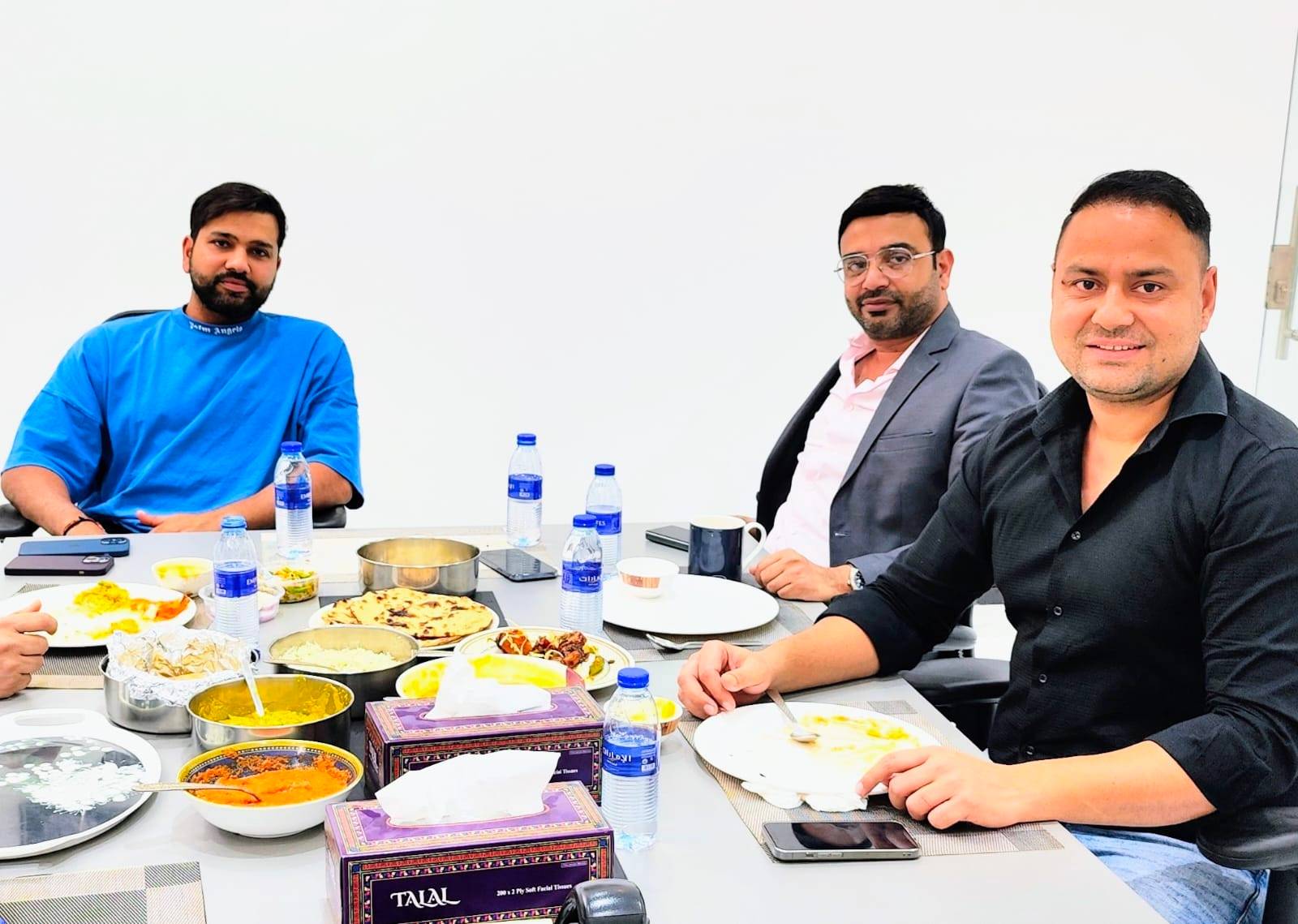 Four men enjoying a meal together